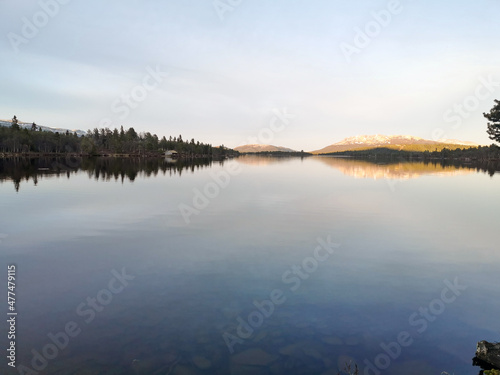 tranquil landscape scenery during blue hour with reflections in water and pink skies. © Jon Anders Wiken