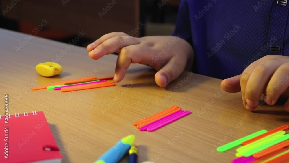 An elementary school student carefully studies mathematical arithmetic. A schoolboy at the workplace does his job. Education concept, modern school, knowledge acquisition, traditional learning. UHD 4K An elementary school student carefully studies mathematical arithmetic. A schoolboy at the workplace does his job. Education concept, modern school, knowledge acquisition, traditional learning. UHD 4K