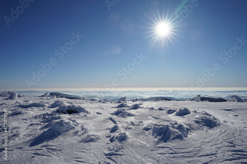 Midday sun rays with panoramic winter landscape and blue sky, Giant Mountains