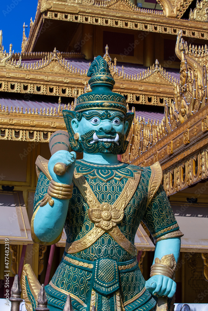 Fototapeta premium Colorful stone statue of a guard in a Buddhist temple in Myanmar, Burma