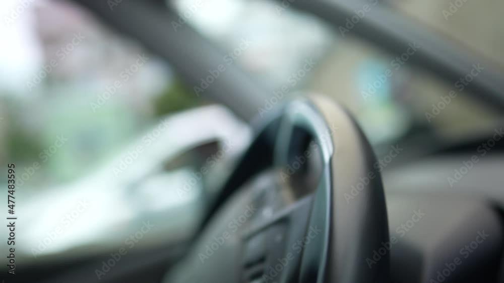 Driver turning left, close-up steering wheel Driver turning left, close-up steering wheel