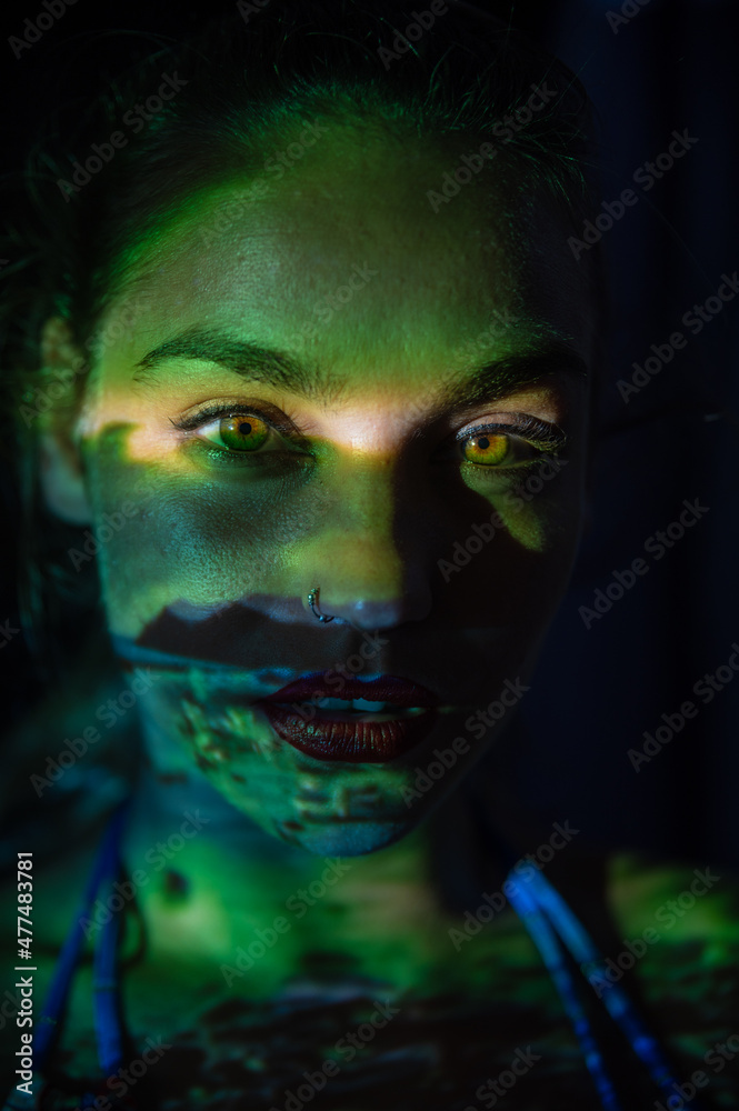 Woman in dark with light projection Woman in dark with light projection