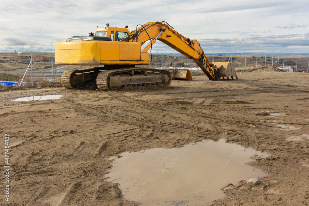 Obraz premium Excavator at a construction site, performing earth moving work