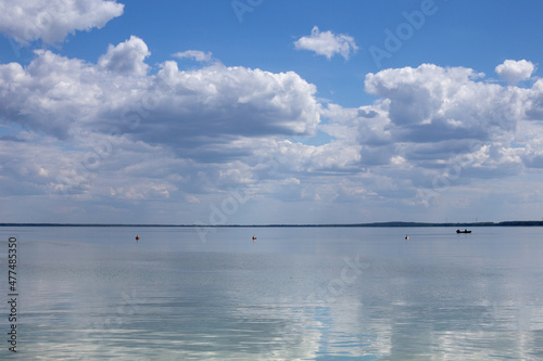 Reflection of white clouds in the mirror of clear water