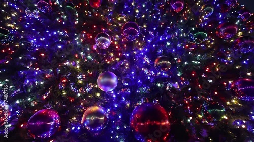 Colorful Christmas balls and garlands on a large Christmas tree