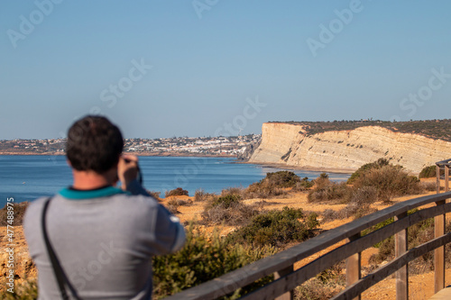 Tourist photographing the coastal beauty