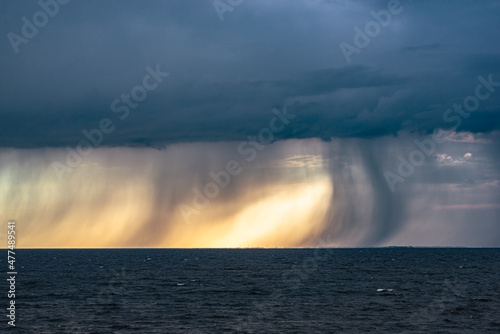 Dramatic image of fallstreaks of rain and hail below the base of thunderstorm over lake IJsselmeer in The Netherlands