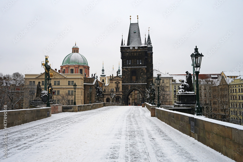 Beautiful atmosphere on empty historic Charles Bridge covered with snow in winter season, Prague cityscape, Czech Republic