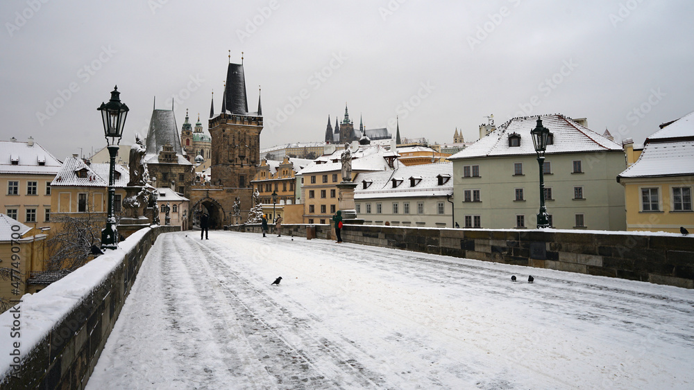 Nobody on historic Charles Bridge covered with snow in winter season, Prague cityscape, Czech Republic