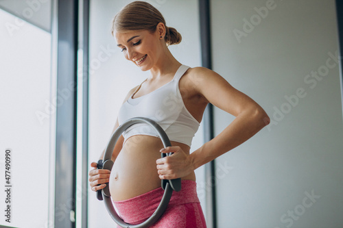 Pregnant woman practicing yoga at home