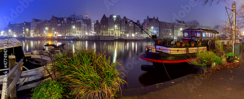 Panorama of the city waterfront of Amsterdam on a foggy morning.