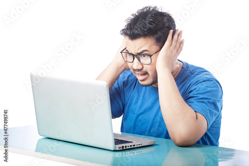 student shrieking expression by looking at laptop screen, surprised expression of a student in front of laptop