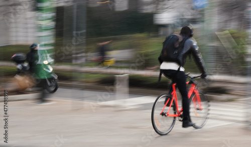 cyclist orange bike motion blur