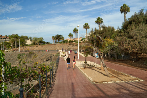 Tourists walking along the promenade in Fanabe, Costa Adeje, Tenerife photo