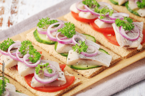 Sandwiches with herring and vegetables