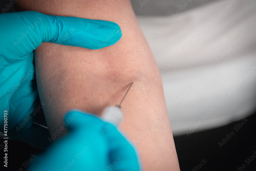 Senior woman (old lady) and syringe, taking blood at home. An elderly lady and her hands. Senior woman (old lady) and syringe, taking blood at home. An elderly lady and her hands.