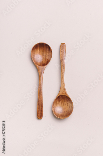 Two wooden spoons on light background. Spoons for soup and spices. Kitchen utensils