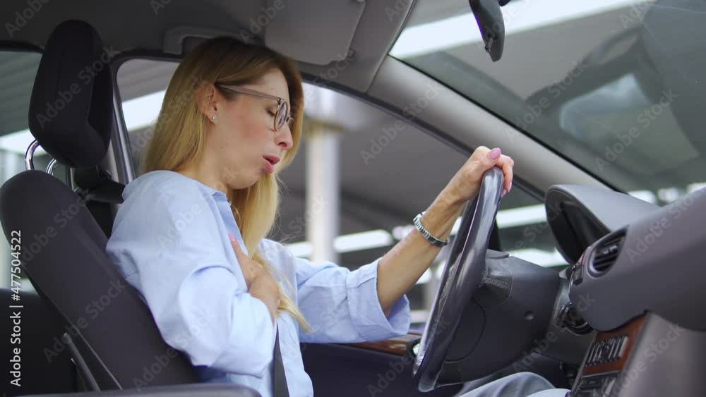Selfconfident woman driver starting coughing holding hand on chest