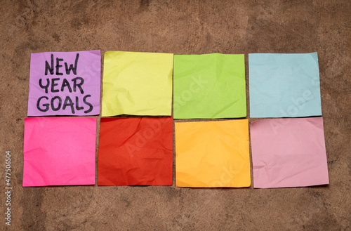 New Year goals - two rows of colorful blank sticky notes, setting goals and resolutions concept