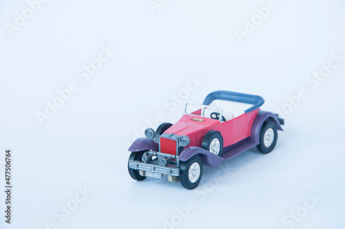 red children's car on a white background. auto sales concept. rare automobile on a light texture. vehicle illustration.