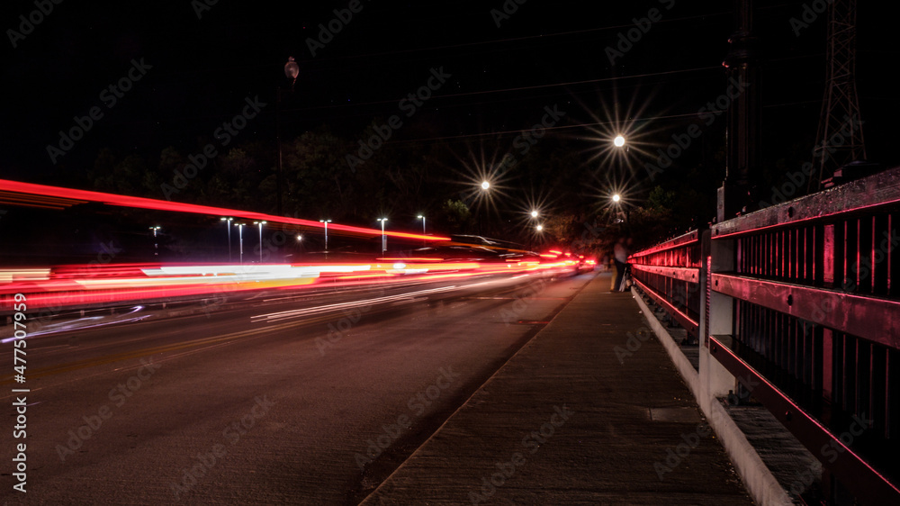 Light streaks from cars on bridge