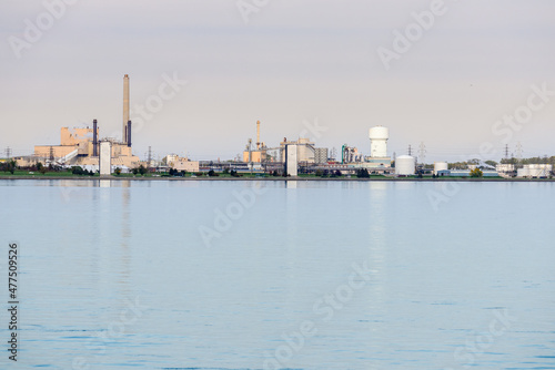 Chemical plant along a river on a cloudy autumn day