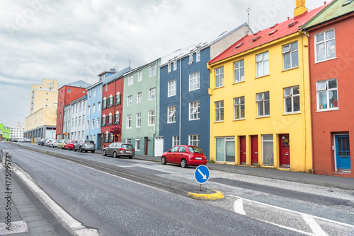 Row of colourful residential buildings along a street on a cloudy day. Reykjavik, Iceland.