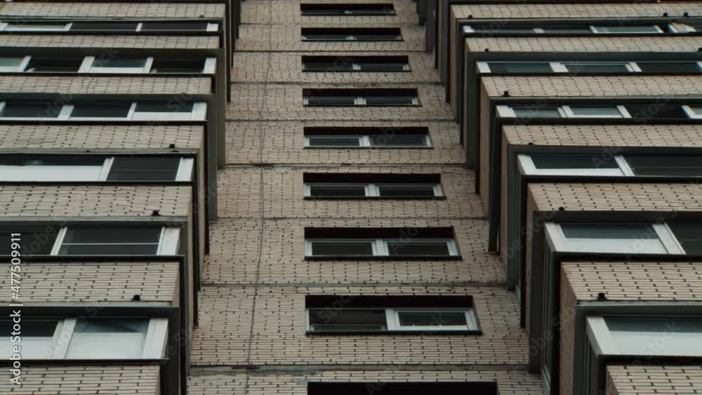 Slow zoom out on a large old panel apartment building