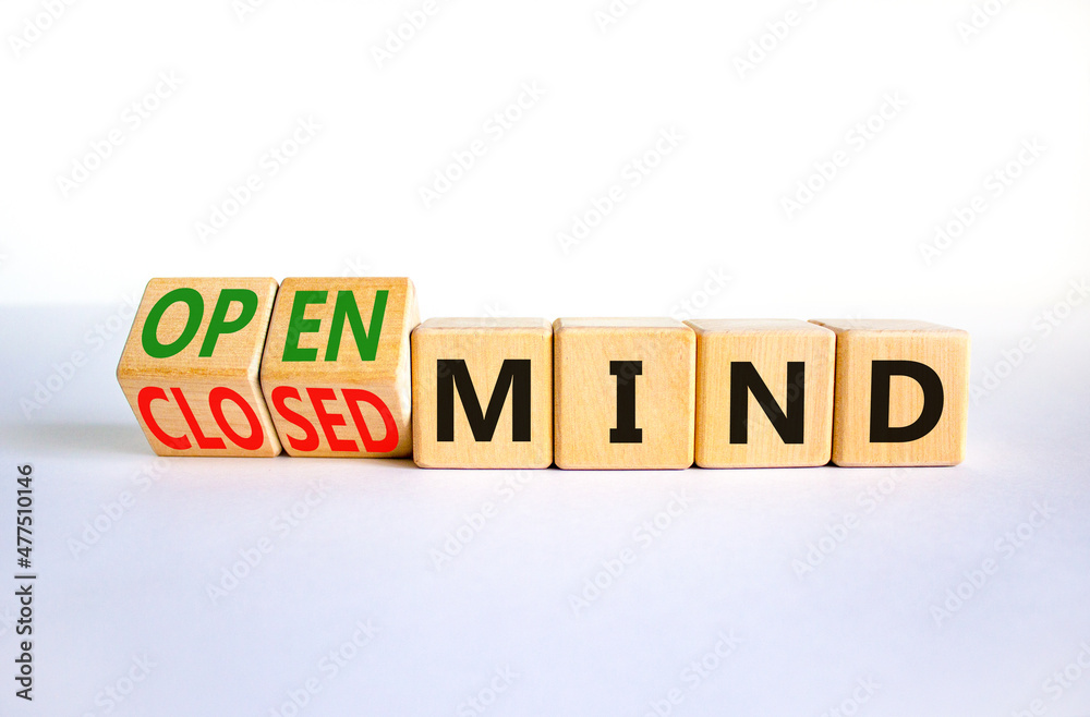 Open or closed mind symbol. Turned wooden cubes and changed concept words closrd mind to open mind. Beautiful white table, white background, copy space. Business open or closed mind concept. Open or closed mind symbol. Turned wooden cubes and changed concept words closrd mind to open mind. Beautiful white table, white background, copy space. Business open or closed mind concept.