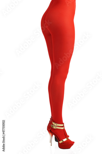 Side view of female legs in red nylon tights and heels