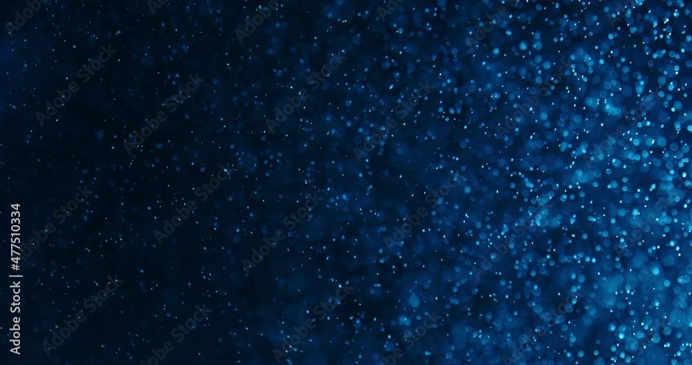 Blue Bubbles And Particles In Water Against Black Background Blue Bubbles And Particles In Water Against Black Background