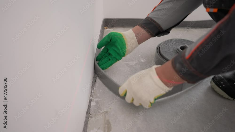 Vidéo Stock Bonding the floor with a damper tape. Installing a damping
