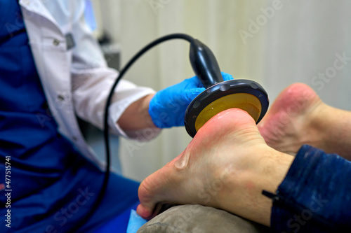 shock wave therapy procedure in the doctor's office photo