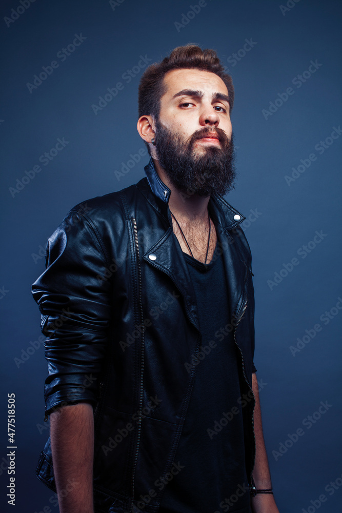 Naklejka premium portrait of young bearded hipster guy smiling on gray background close up, lifestyle people concept