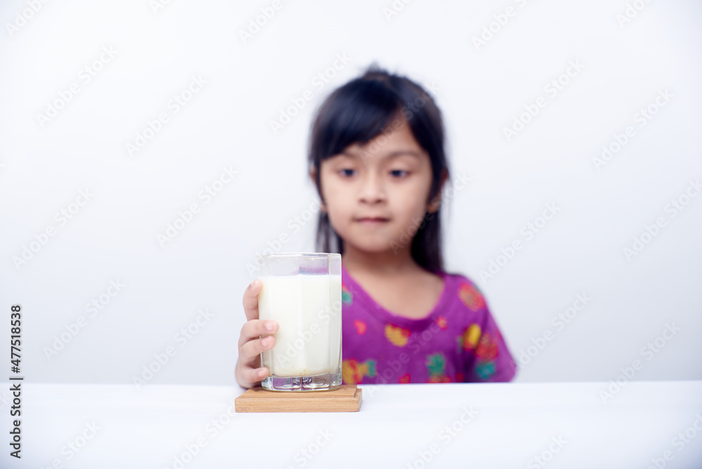 Healthy little Girl drinking a glass of milk on White background Healthy little Girl drinking a glass of milk on White background