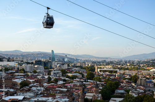 Cable car cabin from downtown Tbilisi to Narikala Fortress and aerial city skyline panoramic view at sunset, Georgia
