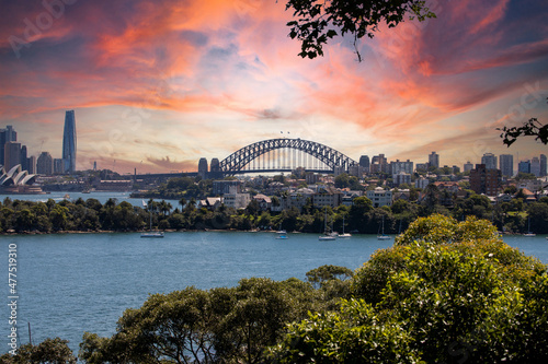 View of Sydney Harbour NSW Australia. Ferry boats partly cloudy colourful skies blue waters