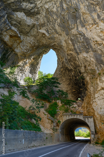 Road and tunnel at Piva Lake in national park Dormitor of Montenegro at summer photo