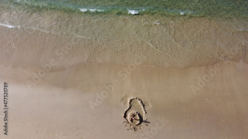 Avocado picture on sand. Aerial view
