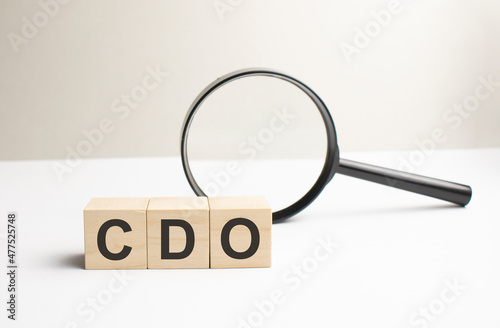 Lettering cdo on wooden cubes on a gray background