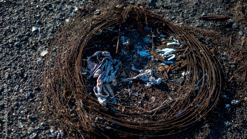 rubble and garbage thrown and abandoned on the street in a vacant lot and abandoned circuit in the canary islands with unrecycled garbage and construction materials cables, thermo photo