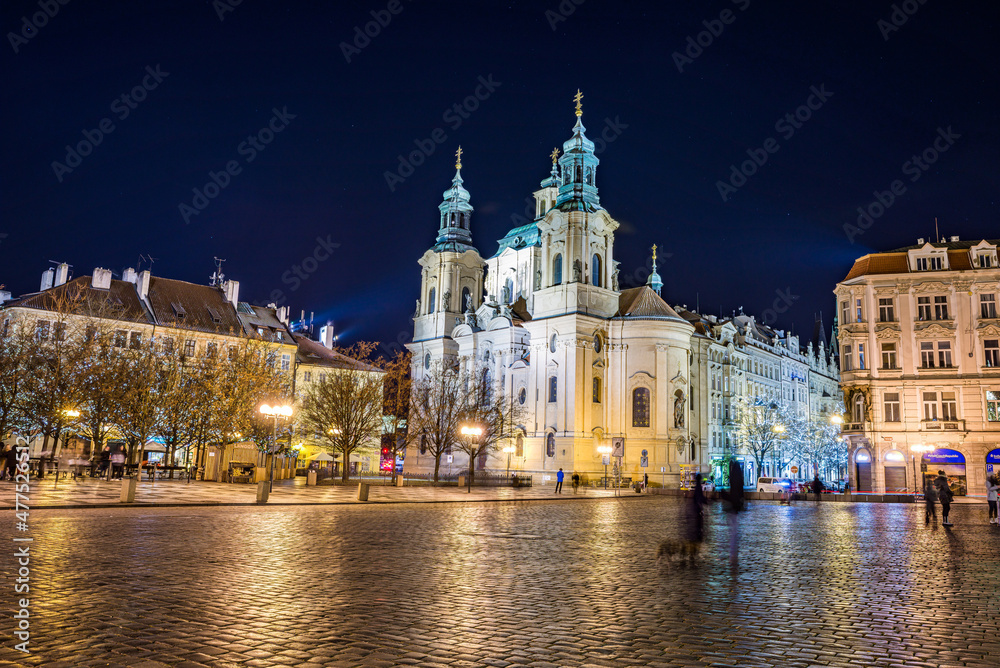 Prague, Czech republic - December 29, 2021. Night photo of Old Town Square without Christmas markets banned due Coronavirus caused empty streets without tourists - St. Nicholas Church