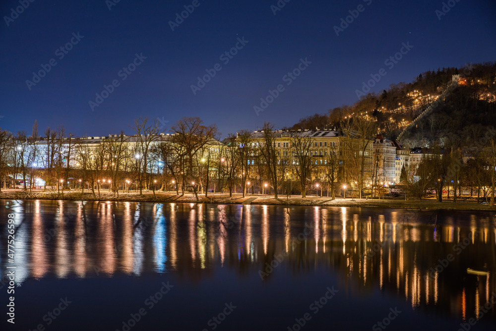 Fototapeta premium Prague, Czech republic - December 29, 2021. Night photo of Strelecky island in Winter with snow