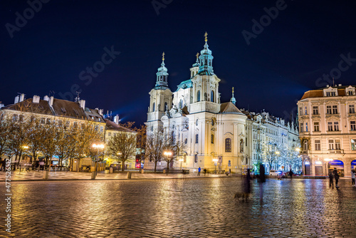 Prague, Czech republic - December 29, 2021. Night photo of Old Town Square without Christmas markets banned due Coronavirus caused empty streets without tourists - St. Nicholas Church