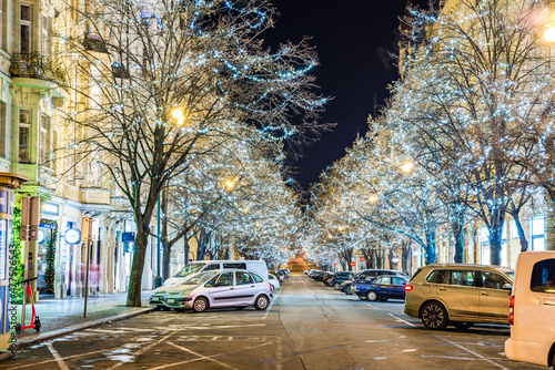 Prague, Czech republic - December 29, 2021. Night photo of Parizska street without Christmas markets banned due Coronavirus caused empty streets without tourists - trees full of christmas lights
