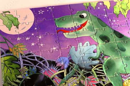 Complete puzzle. Green dinosaur at night. Many small details. Children s puzzle entirely finished.