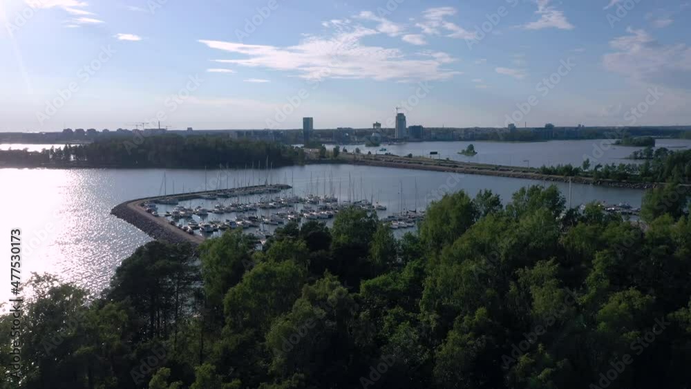 Helsinki.Finland-July 17.2019 Drone shot of the trees on the Gulf of Finland in Helsinki with the view of the boats on the Baltic Sea in Lauttasaari Helsinki.Finland-July 17.2019 Drone shot of the trees on the Gulf of Finland in Helsinki with the view of the boats on the Baltic Sea in Lauttasaari