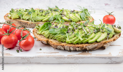 healthy breakfast with avocado toast and tomatoes 