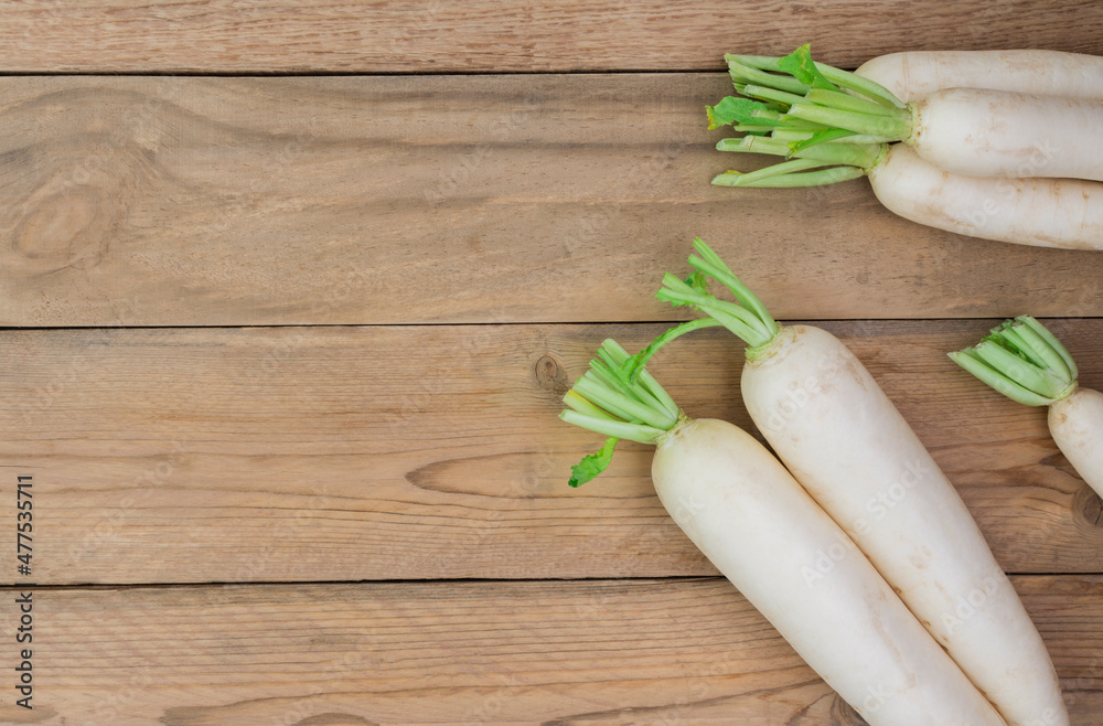 white radish on rustic wooden table with copy space - top view white radish on rustic wooden table with copy space - top view