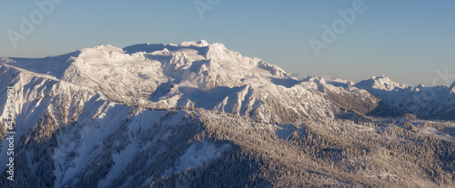 Aerial Panoramic View of Canadian Mountain covered in snow during sunny winter evening. Located near Vancouver and Squamish, British Columbia, Canada. Nature Background Panorama